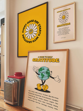 Set of 3 inspiring gratitude prints for the home. The artwork prints are framed arranged on a wall and resting on the floor.