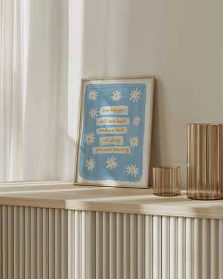 Uplifting daisies spring art print in modern living room. Daisy positive quote feel good poster. Blue watercolour art print with butter yellow floral daisies illustration. Daisy painting art print