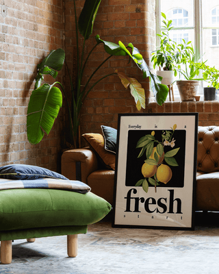 Contemporary lemon art print in apartment lofts. Modern black frame with positive quote.
