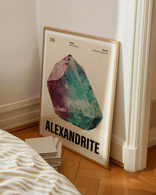 June birthstone art print with cream background in contemporary white bedroom. Wooden framed poster with alexandrite crystal illustration for June birthdays and Christmas gifting.
