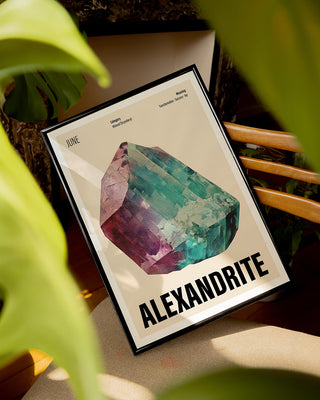 Bold June birthstone art print with cream background in contemporary living room surrounded by plants. Black framed poster with alexandrite crystal illustration for June birthdays and Christmas gifting.