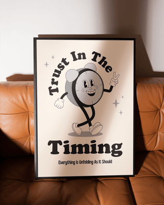 Trust in the timing retro hand-drawn art print. Black framed poster on brown leather retro sofa.