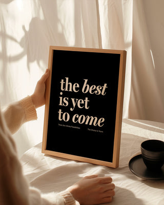 Print reading "the best is yet to come" in black. affirmation print manifestation print mental health prints positive quote print. Woman holding motivational framed print with coffee