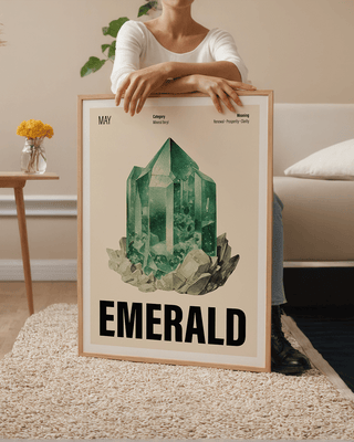 Vintage-inspired May birthstone poster featuring a watercolour emerald illustration. Woman leaning on large framed poster with May crystal illustration.