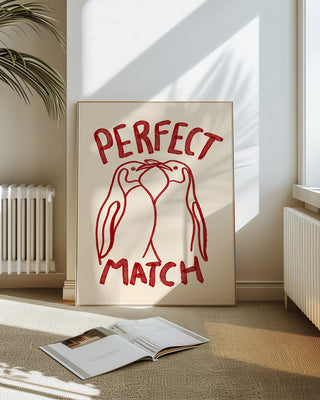 A premium art print that reads perfect match in a white bright living room. The poster features a illustration of two penguins and is hand-drawn in watercolour brushes. Unique gift for valentines day, anniversaries or a loved one.