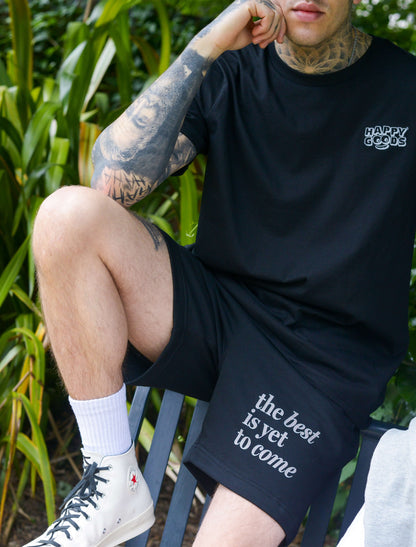 The best is yet to come shorts. positive messaging mental health shorts. Male model wearing black and grey positive affirmation shorts