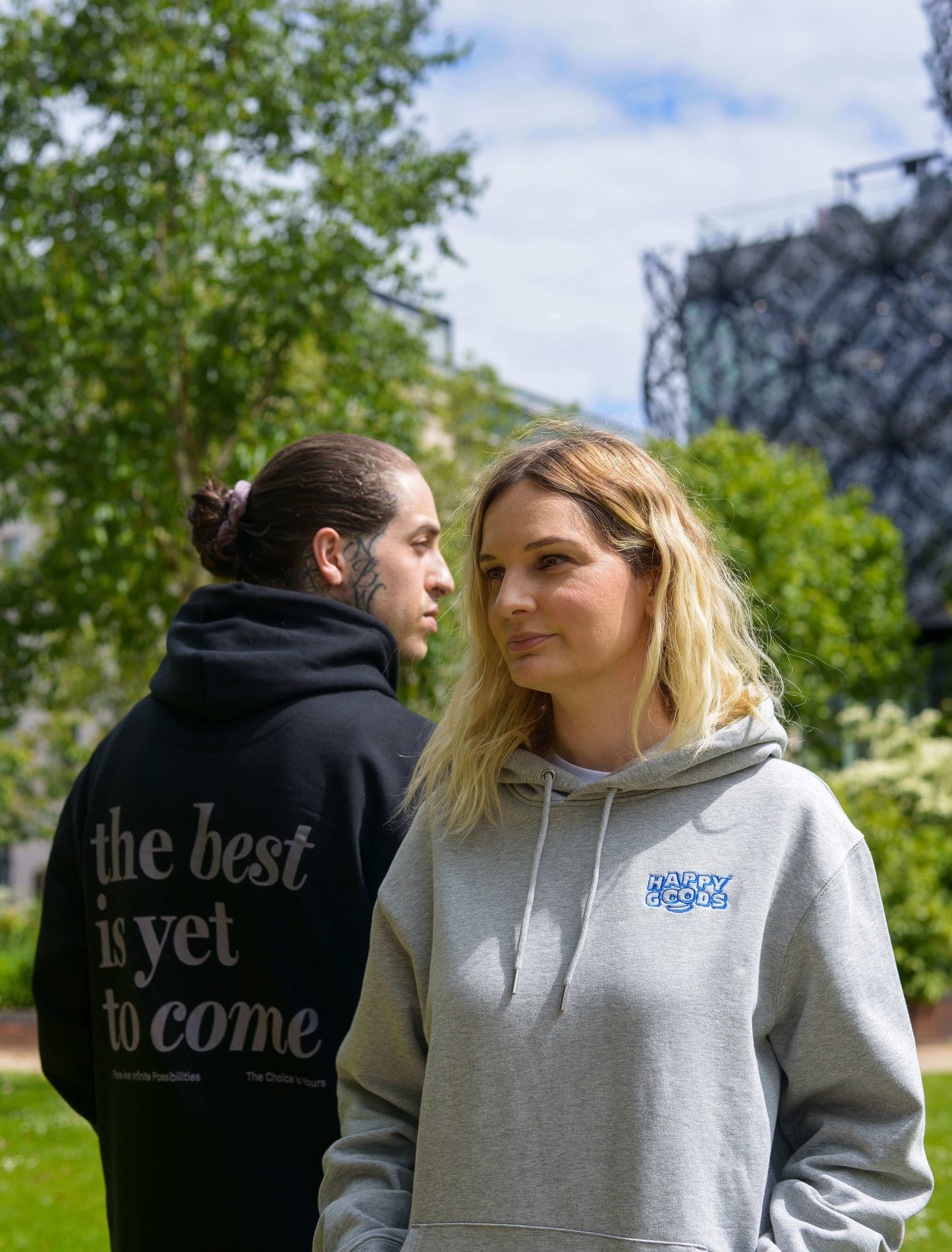 The best is yet to come hoodie. positive messaging mental health hoodie. Pair of models front to back wearing matching set of affirmation clothing in park