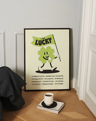 I am lucky poster framed in black in a modern living room.