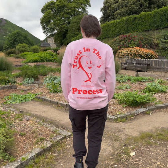 Positive pink trust in the process sweater