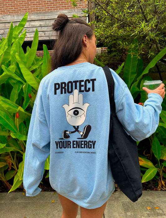 Protect your energy hamsa hand sweater in baby blue, model wearing oversized
