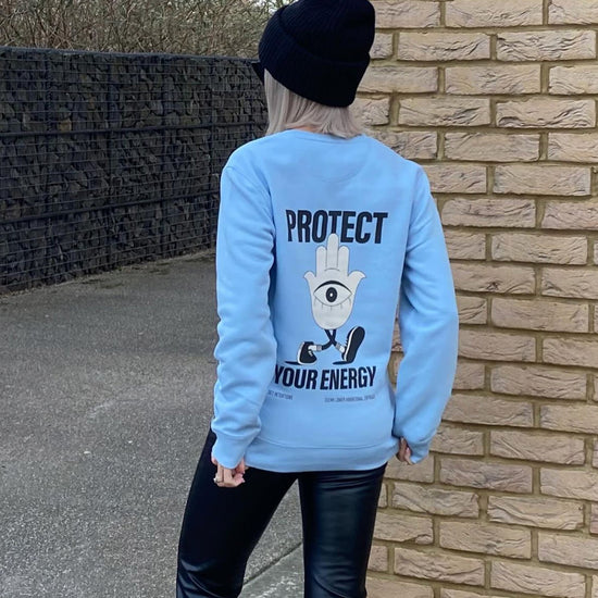 Protect your energy jumper, sweater. Woman wearing unisex positive affirmation sweatshirt in baby blue
