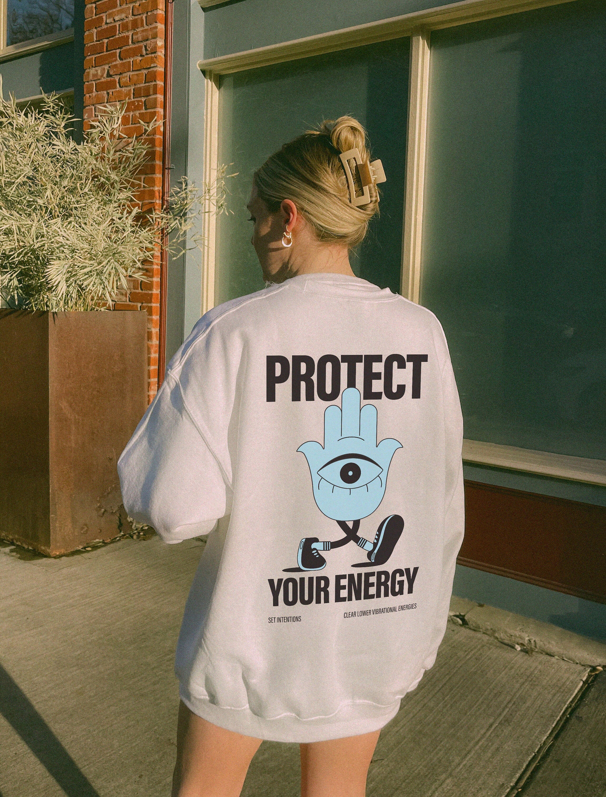 Protect your energy hamsa hand sweater, model wearing oversized