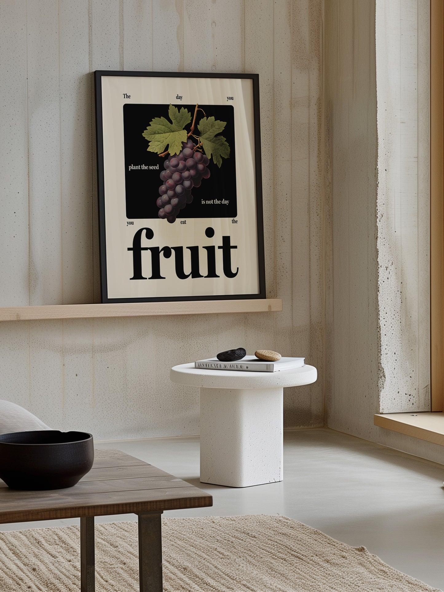 Motivational fruit art print in black frame rests on shelf in inspiring home space.