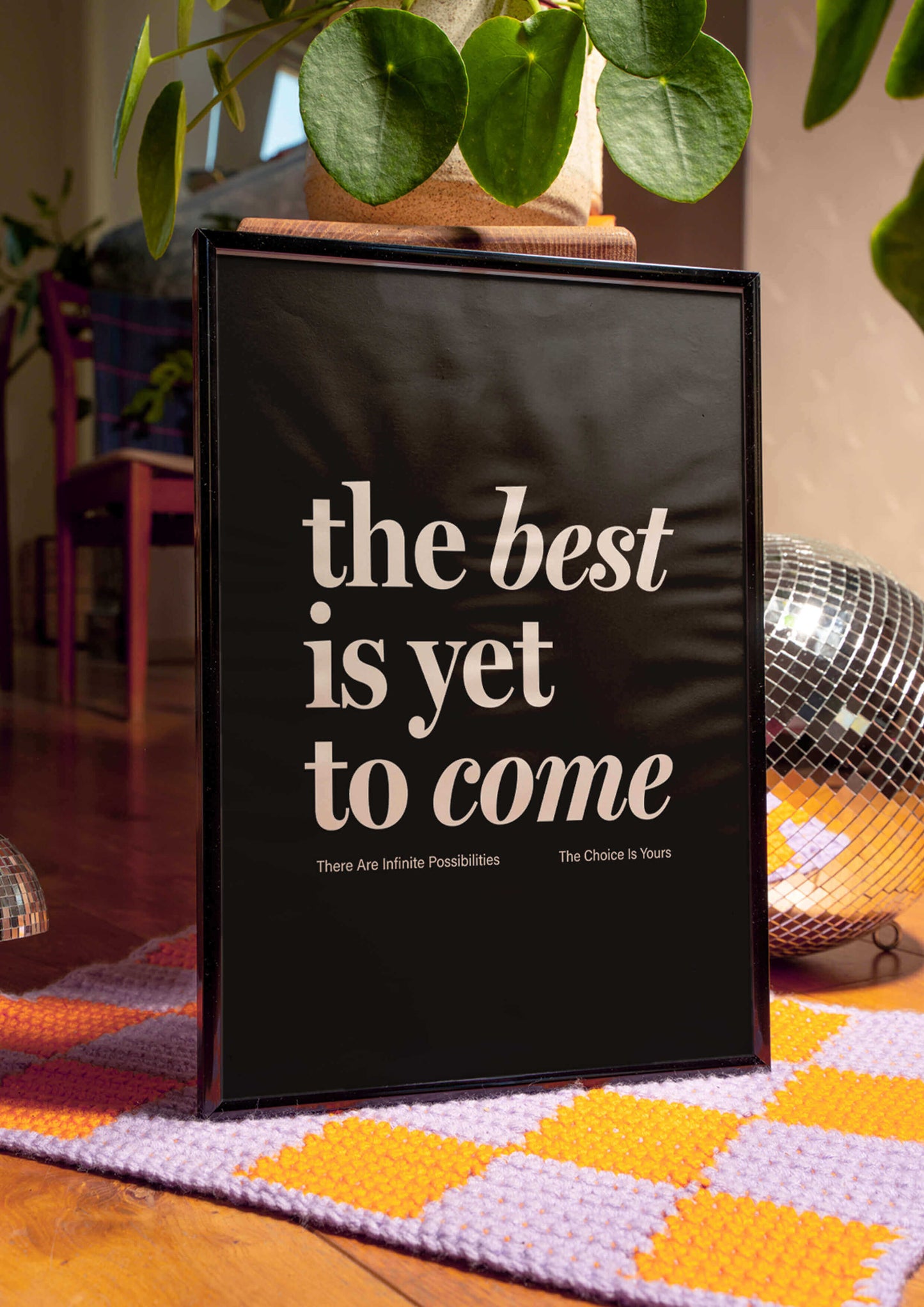 Framed rint reading "the best is yet to come" in black. affirmation print manifestation print mental health prints positive quote print. Framed print in quirky living room with silver disco ball