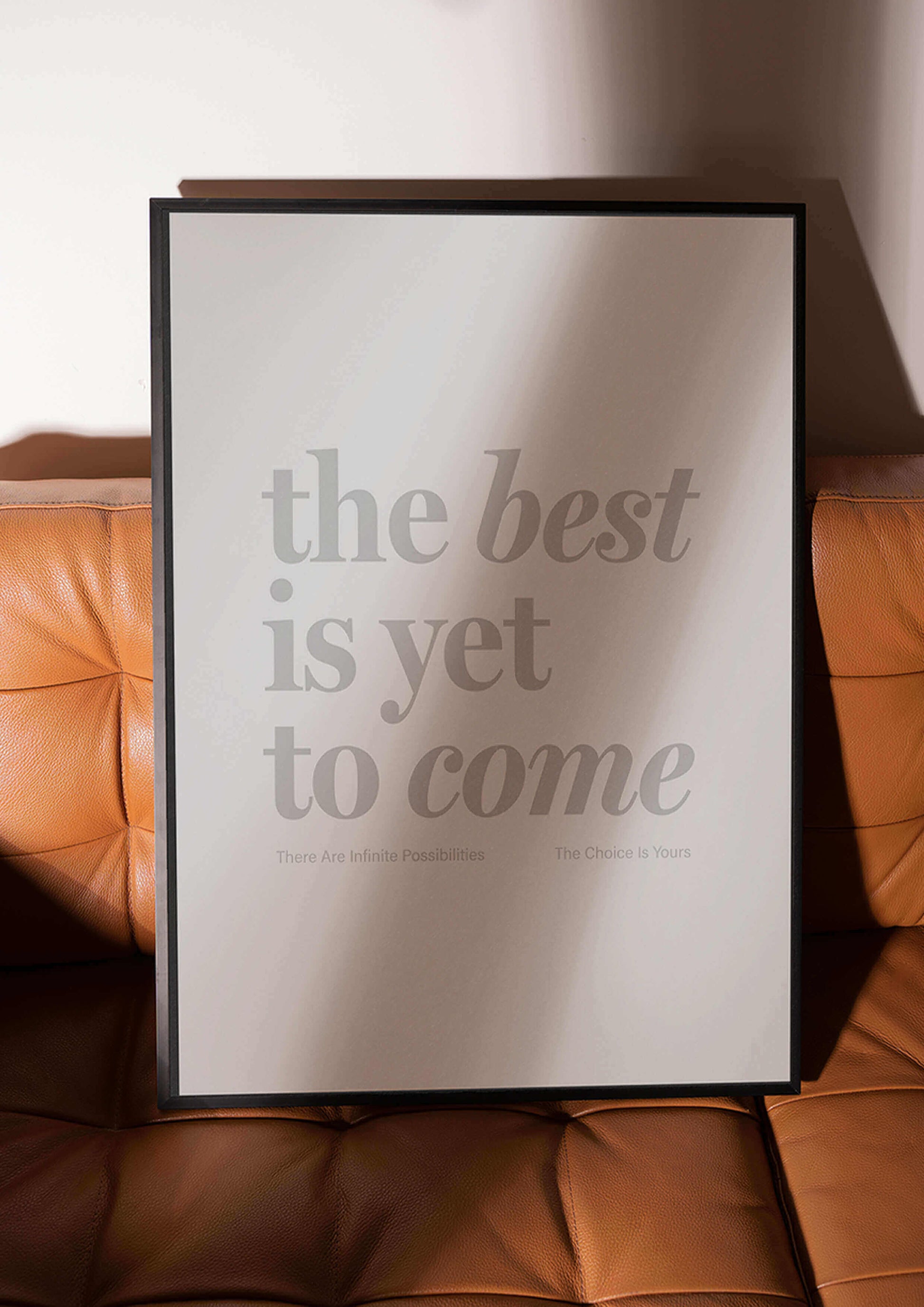 The Best Is Yet To Come framed Print - Black framed print sitting on tan leather sofa