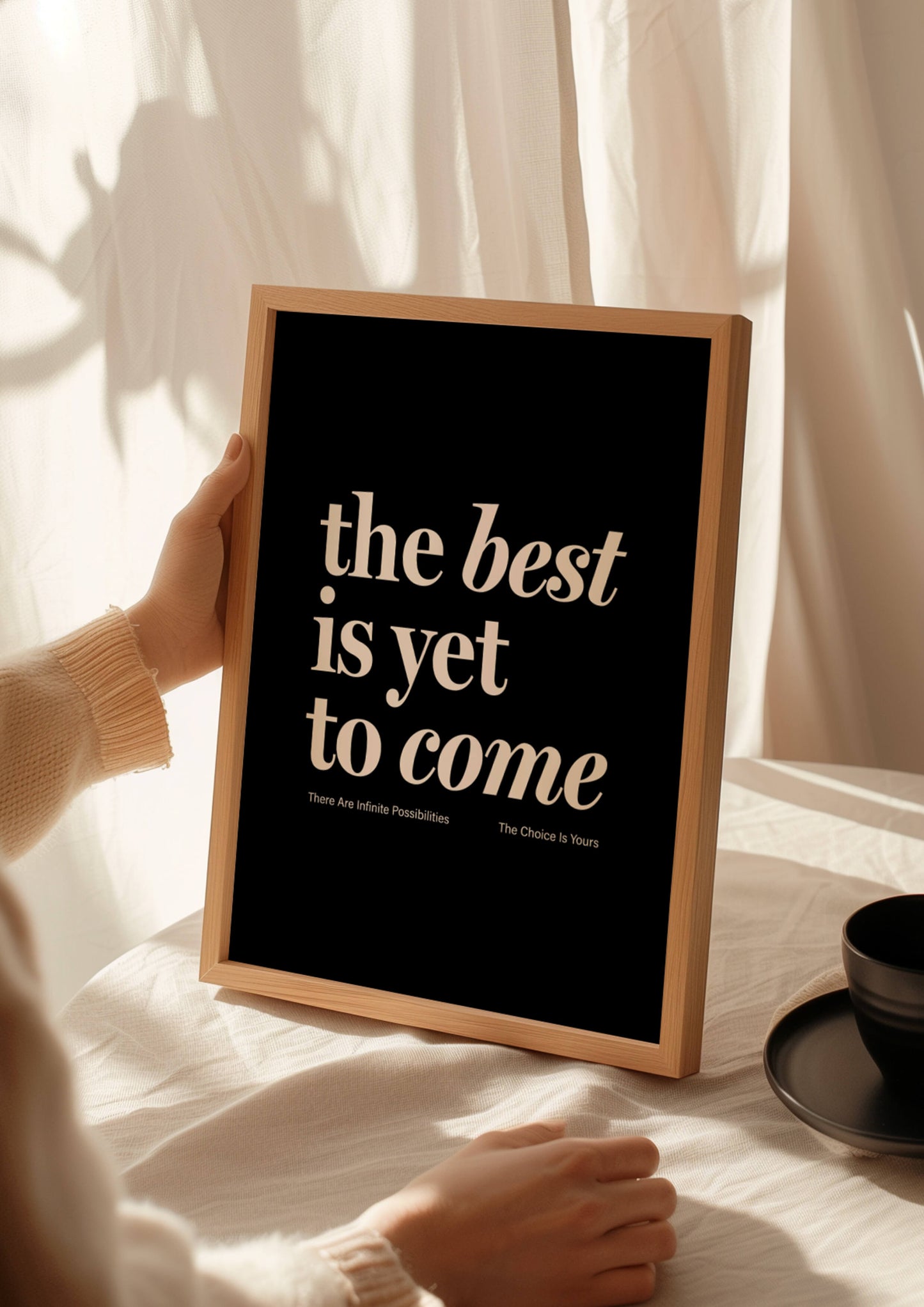 Print reading "the best is yet to come" in black. affirmation print manifestation print mental health prints positive quote print. Woman holding motivational framed print with coffee