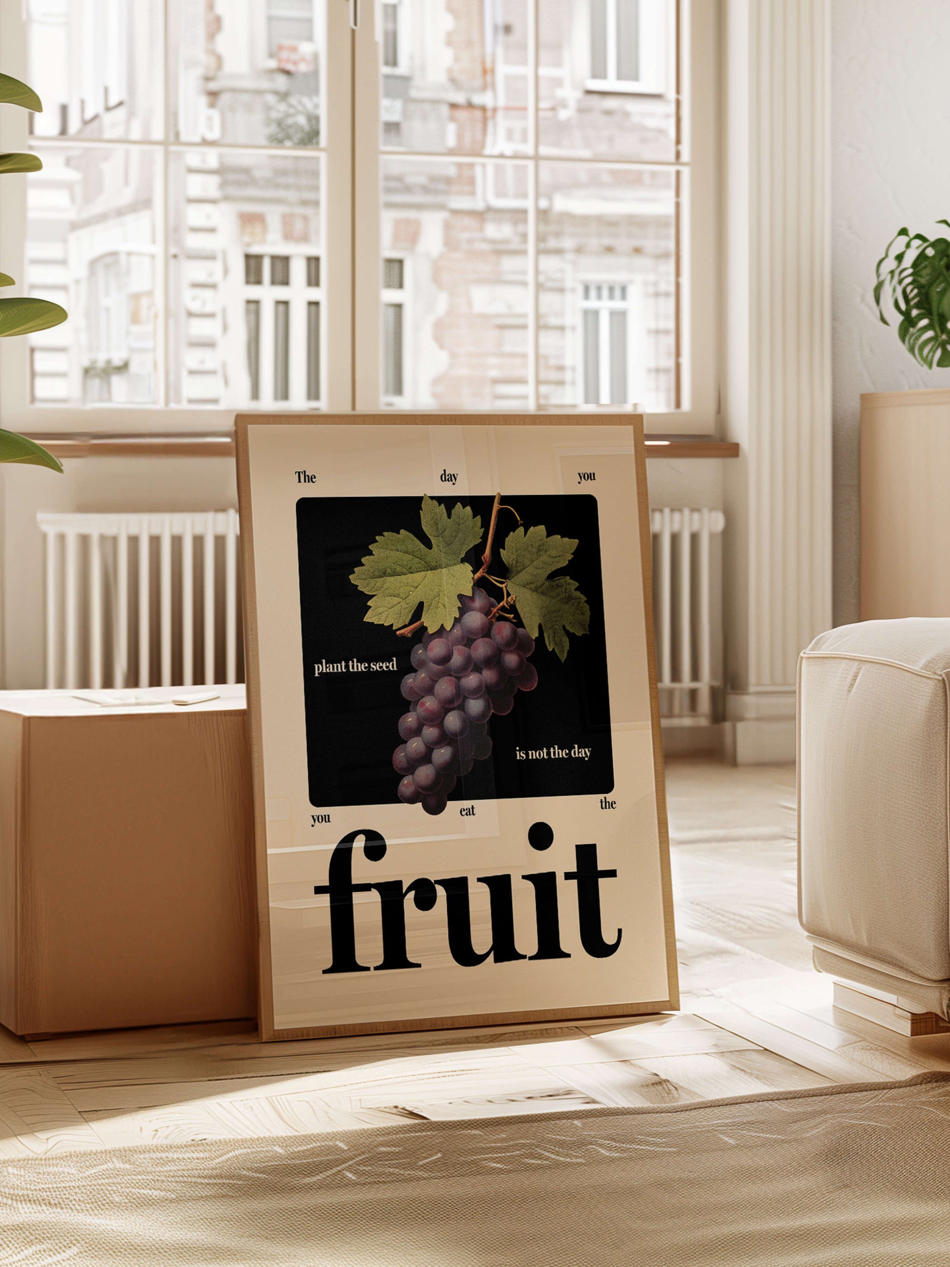 Motivational fruit art print in wooden frame rests against coffee table in beautiful apartment living space.