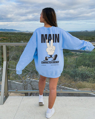 Model wearing oversized main character energy sweater in blue