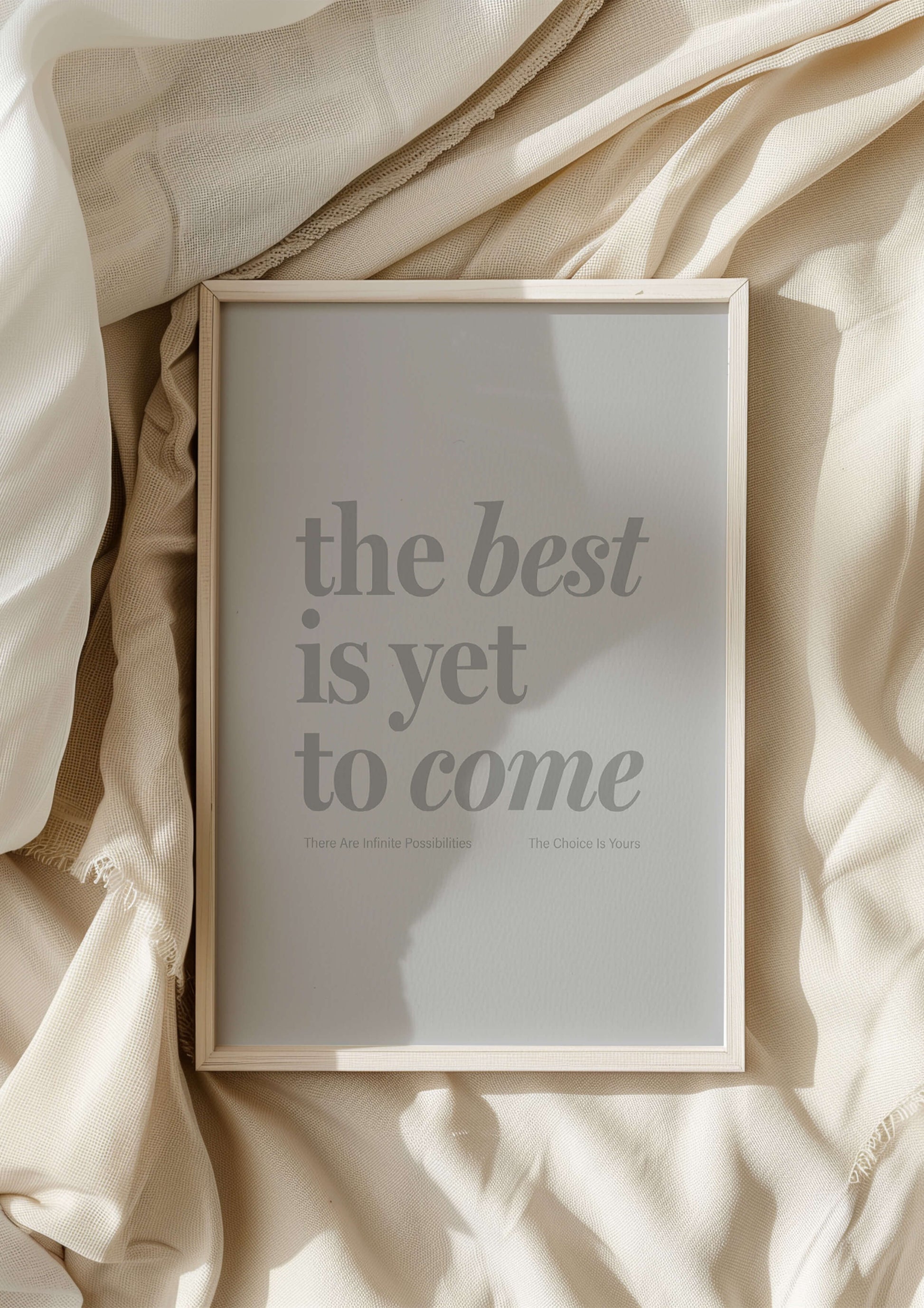 The Best Is Yet To Come framed print - Print in natural wooden frame resting on bedsheets